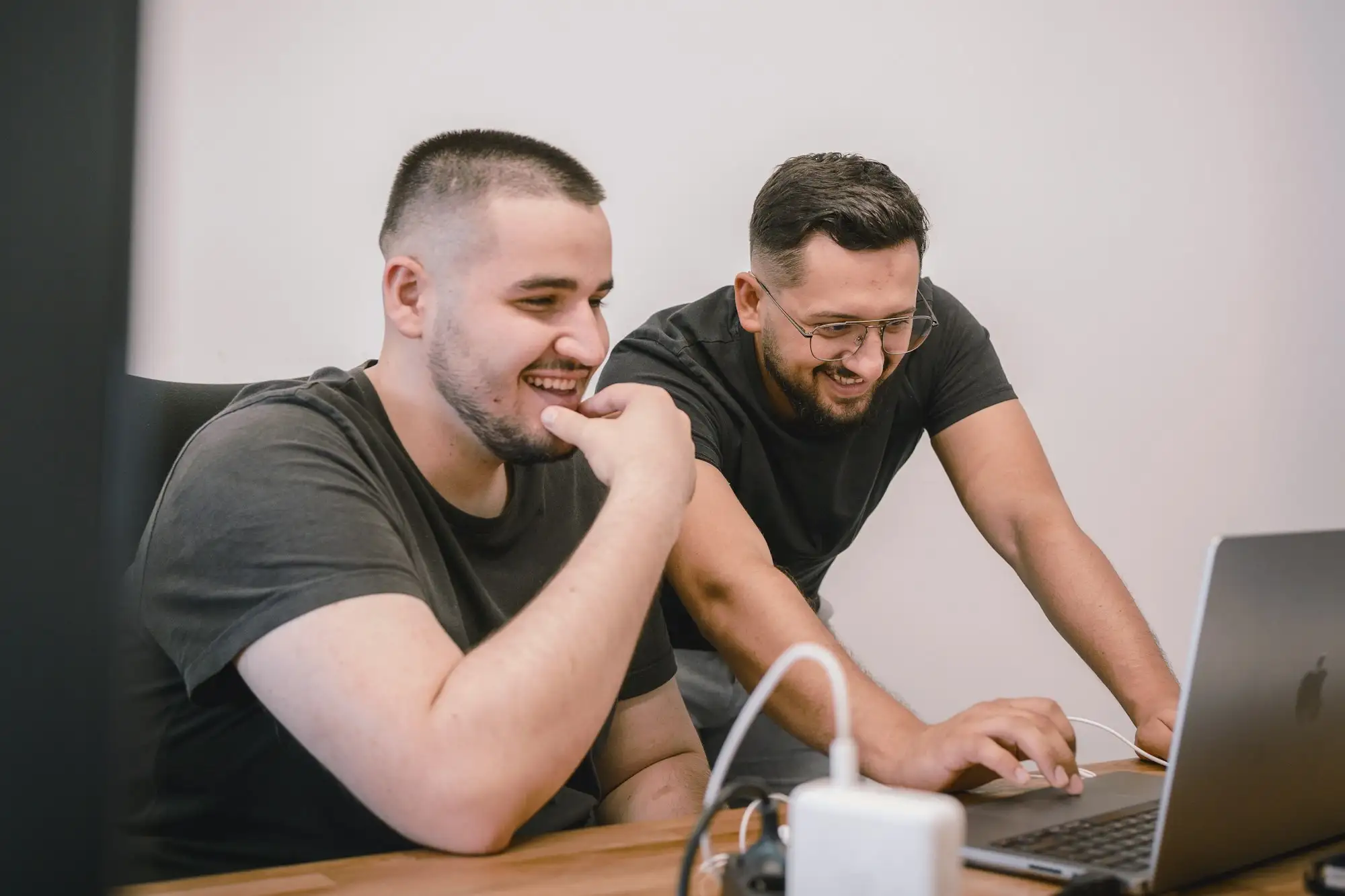 Two people at a table looking at a laptop together